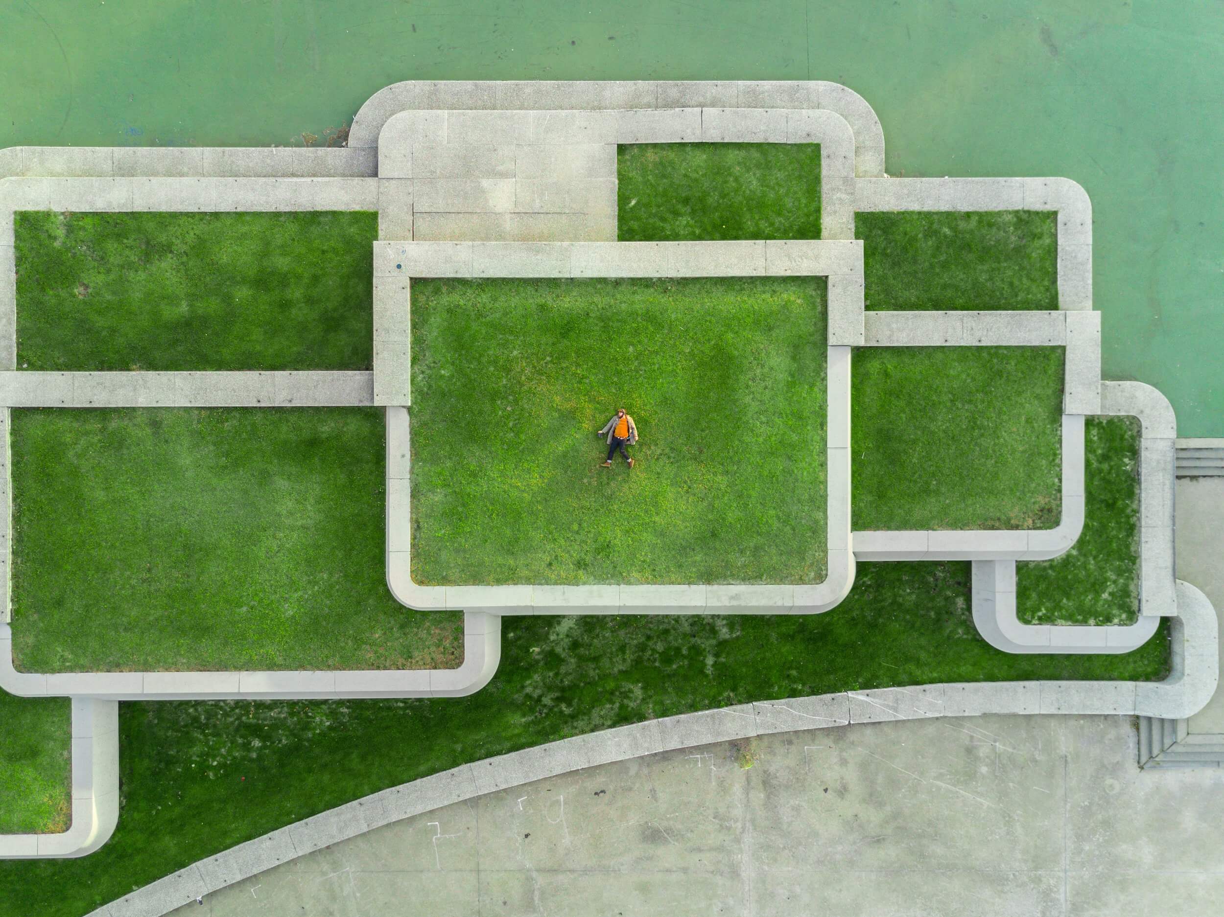 Aerial of Person Laying inn Squares of Lawn